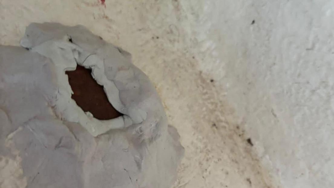 A hole in the footwell of the ships cabin. It has putty wrapped around the edges to try and stem the flow of water. 