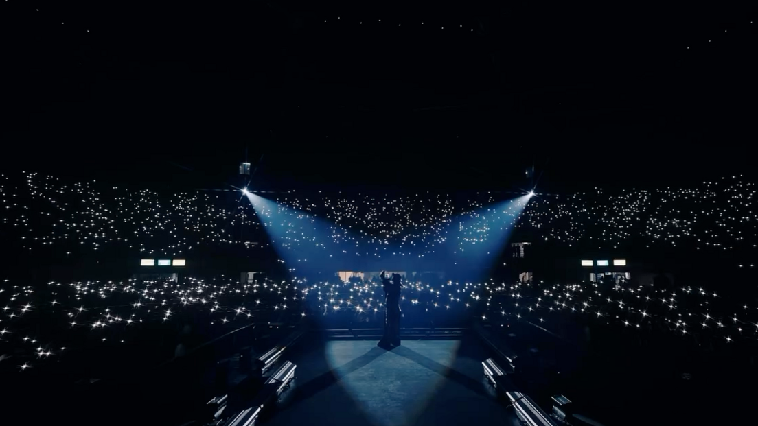 Spotlights flash over Reshammiya as he sings in front of thousands of people gathered at a stadium in Delhi for his show