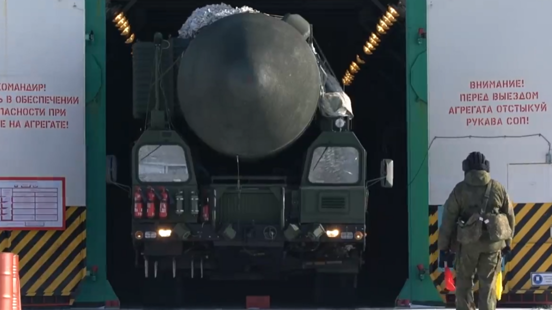 A ballistic missile is wheeled out of a warehouse on a nuclear base in Russia