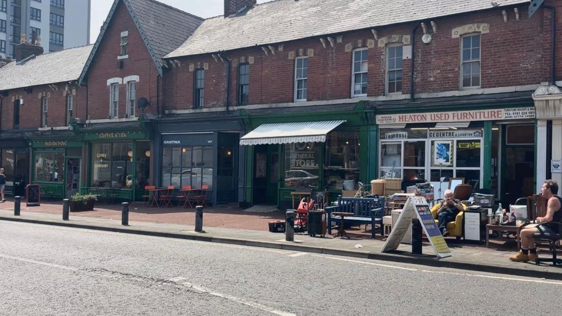 Row of shops including Heaton Perk Cafe and 109 General Store on Heaton Park road in Newcastle.