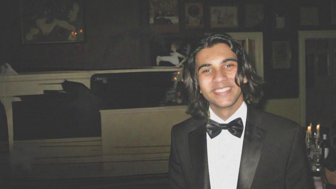 Abdullah Shahid Sial in a black suit and bowtie at an event in school