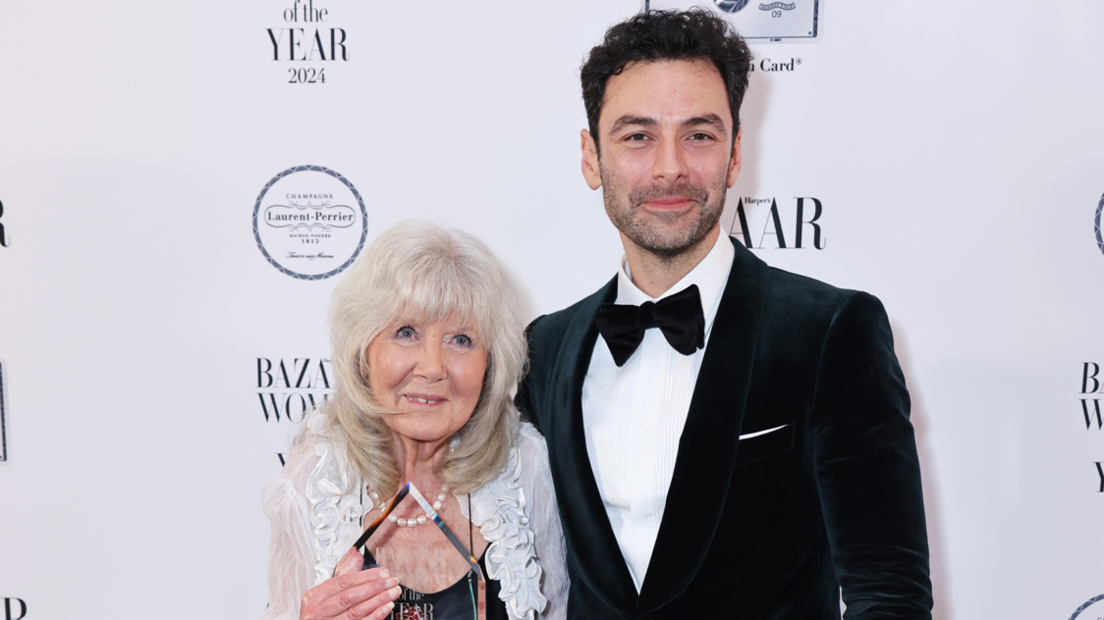 Dame Jilly Cooper and Aidan Turner smiling 