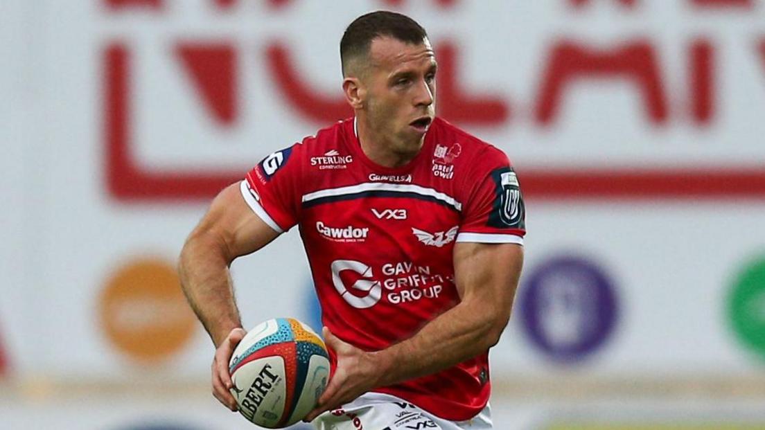 Wales scrum-half Gareth Davies attacks with the ball for Scarlets against Munster