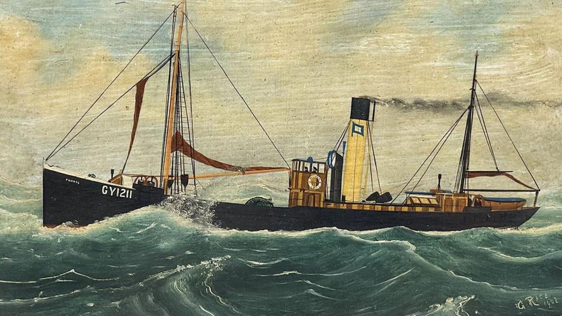 The trawler Pharos is black and has GY1211 written on the side. There are two masts, one at each end, and a wooden deck