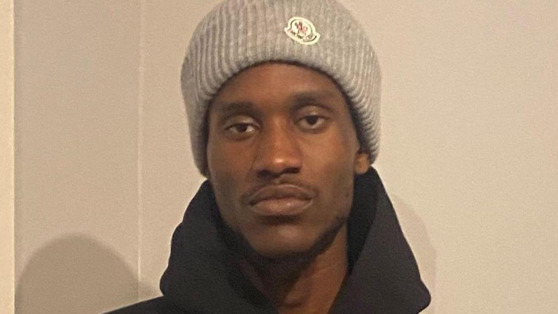 Messiah Robb in a grey knitted hat and a black hoodie.