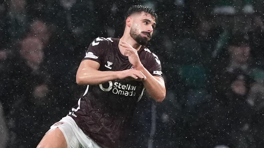 Claudio Braga jumping up to celebrate a Hearts goal