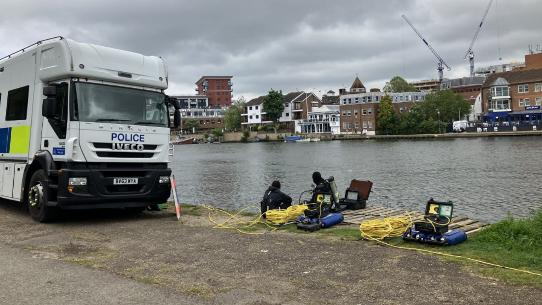 Divers by the river