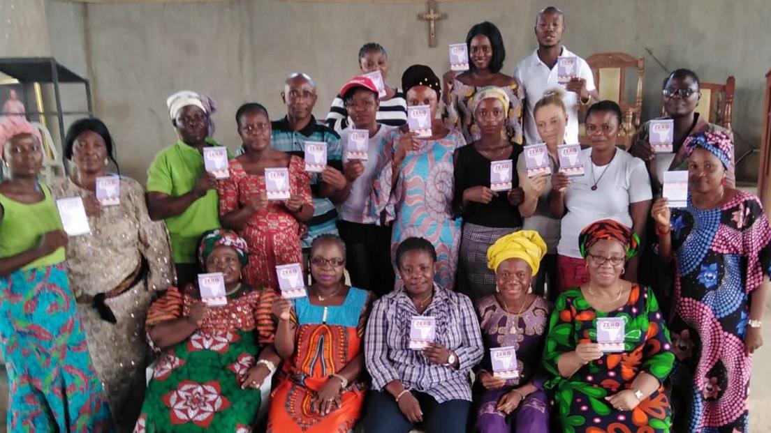 Group of women, including Ms Amusan-Fagborun, holding up "zero tolerance" cards