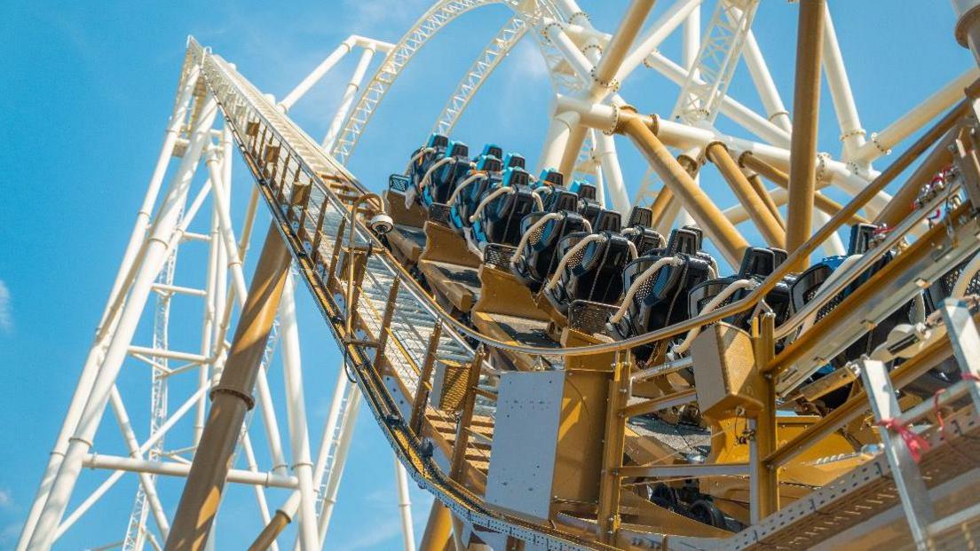 The Hyperia rollercoaster at Thrope Park. There are black seats and a white and yellow frame. 