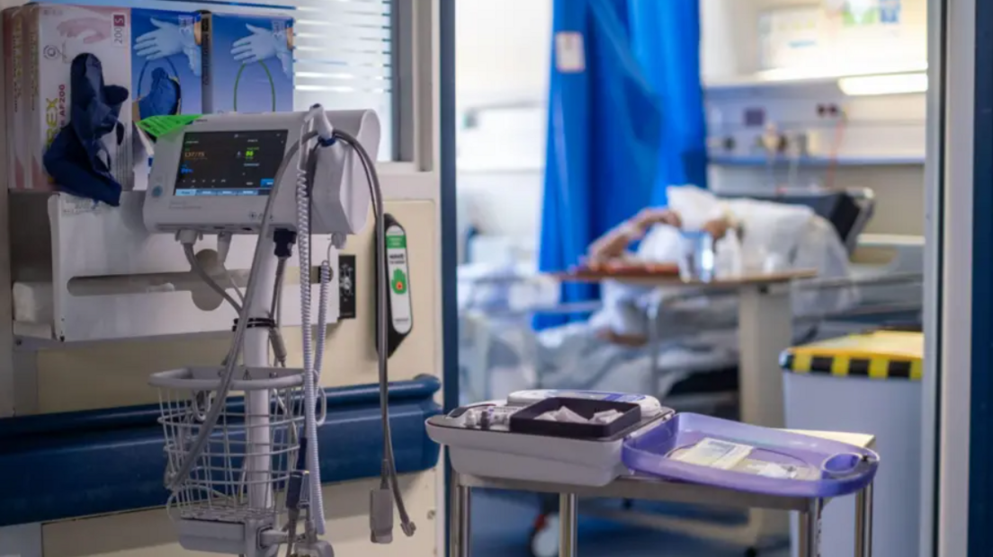 A wide shot of a hospital bed and equipment.