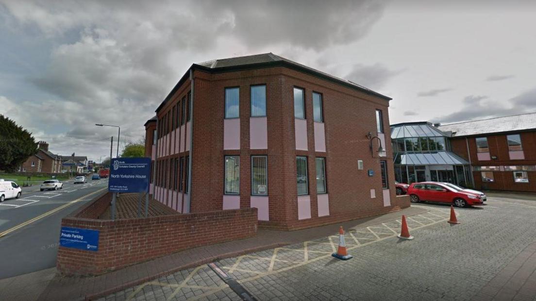 A two-storey red brick office building.