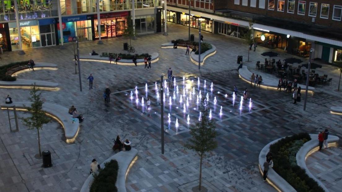 The Queens Square fountains in Crawley, lit up