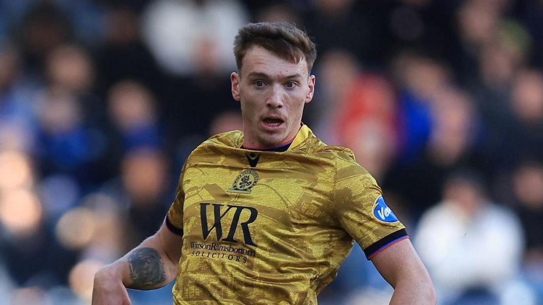 Hayden Carter looking up while in action for Blackburn Rovers.