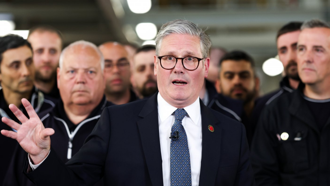 UK Prime Minister Keir Starmer (centre) speaks to the media after a phone conversation with US President Donald Trump, at a Jaguar Land Rover automobile manufacturing plant in the West Midlands back in May. JLR workers are crowded behind him.