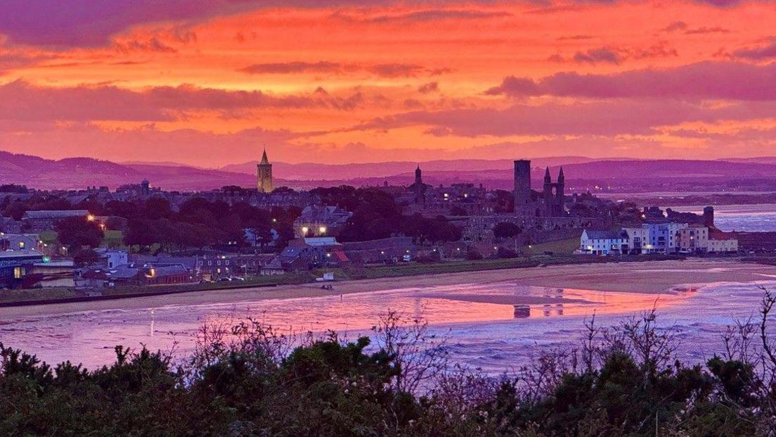 Purple and peach sunset over the seaside and coastal houses at St Andrews.