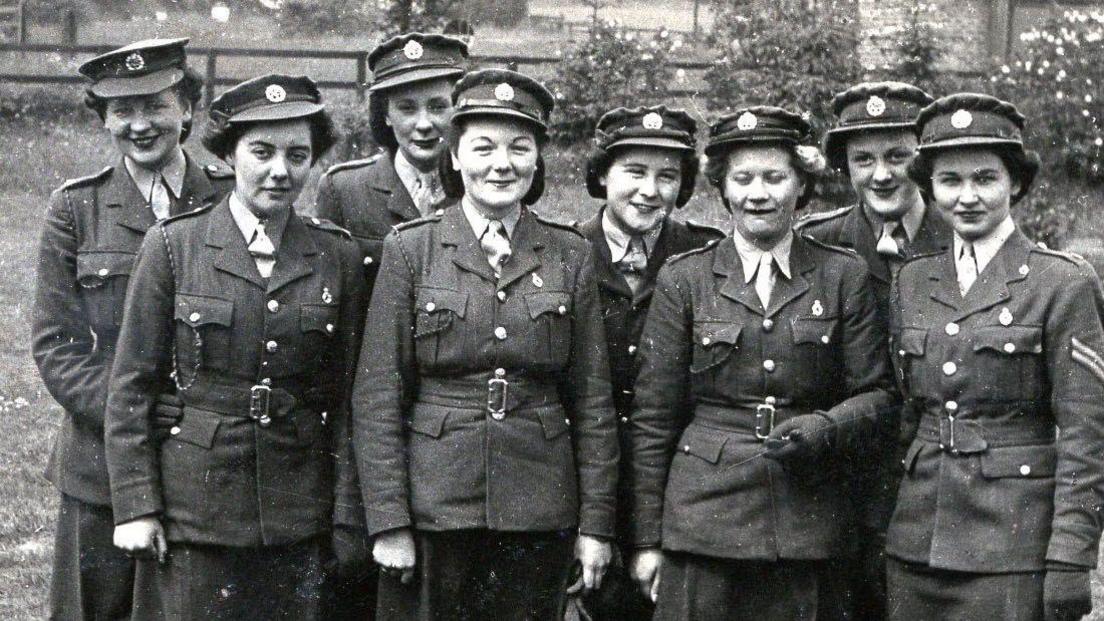 A black and white photograph of Christina Hartnell in uniform with seven other women.