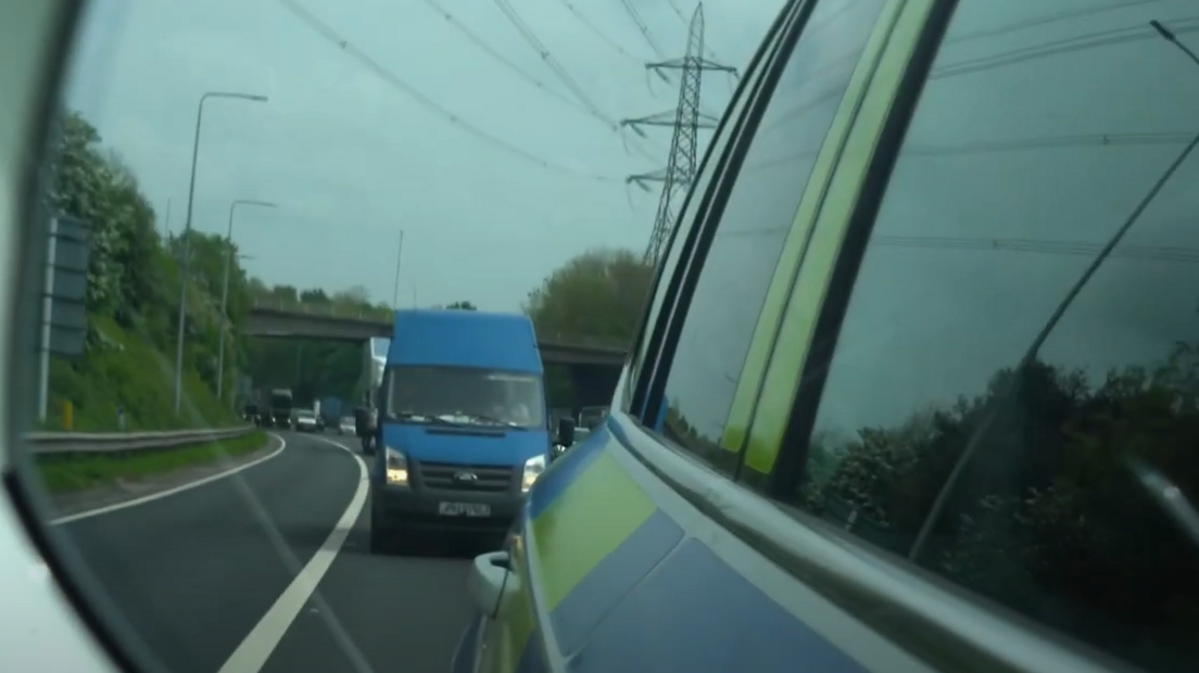 An HGV in the wing mirror of a police vehicle