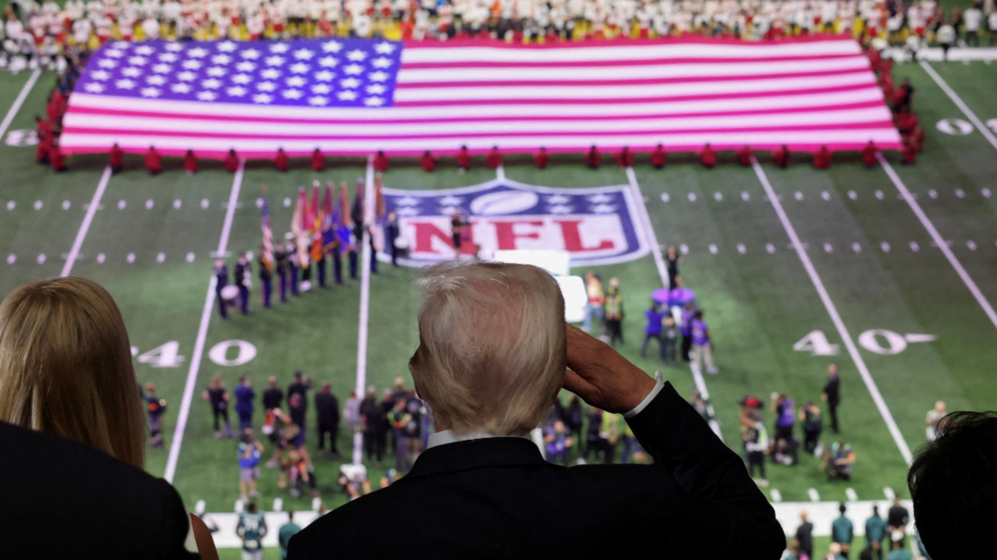 President Donald Trump salutes as the national anthem is sung by Jon Batiste

