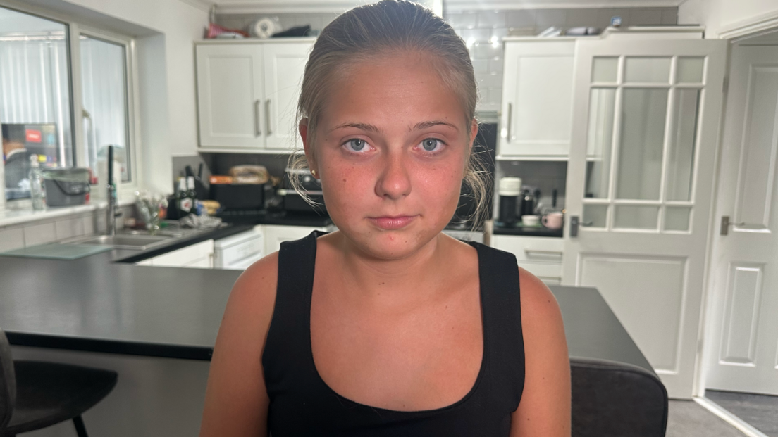 Chloe sat in her kitchen looking down the camera