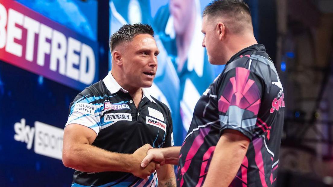 Gerwyn Price and Daryl Gurney share a robust handshake after their match in Blackpool