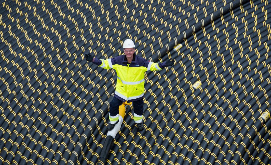 Worker standing on coil of subsea cable