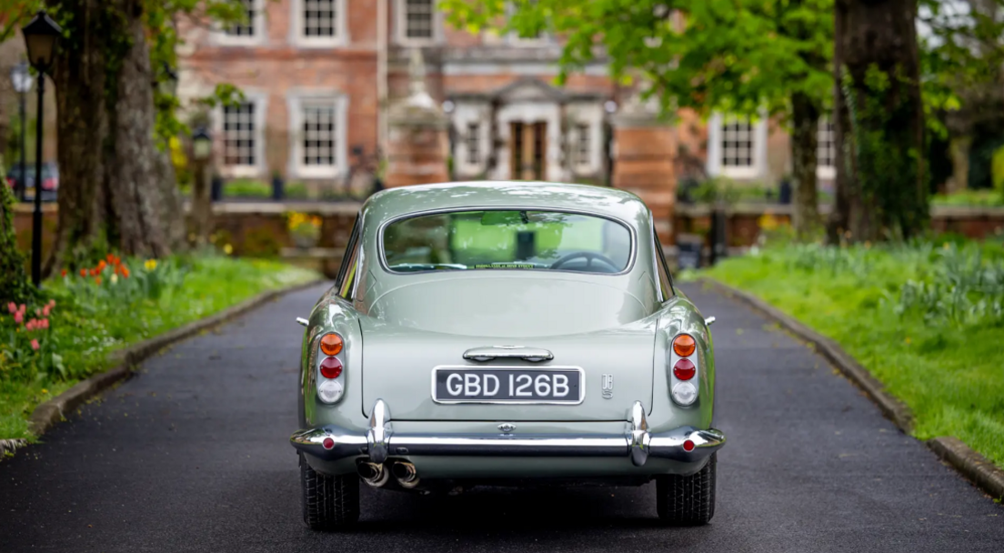 Sage green Aston Martin DB5  from the back showing the number plate