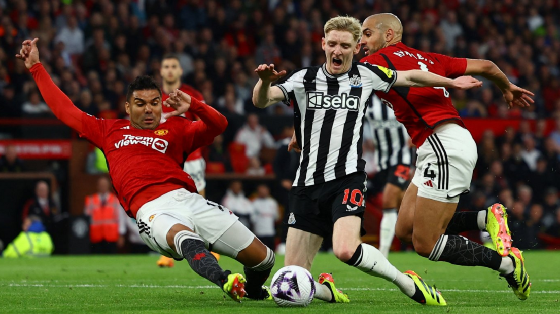 Anthony Gordon appears to be fouled by Manchester United's Sofyan Amrabat