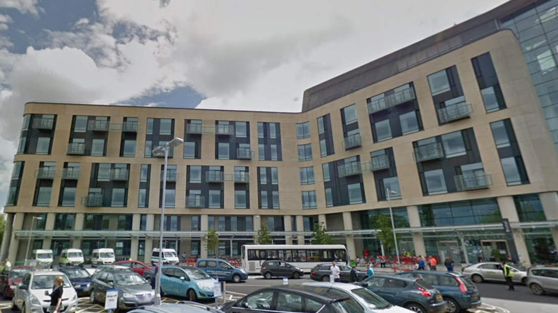 Main entrance to Southmead Hospital with cars and buses outside