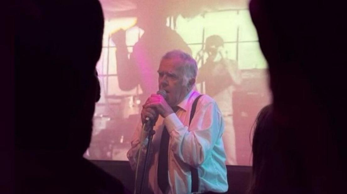 Tony Morris singing in a club