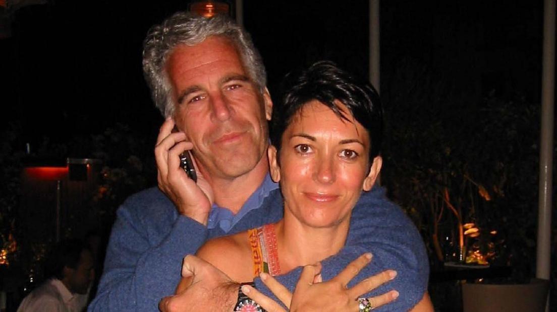Jeffrey Epstein has an arm around Ghislaine Maxwell and speaks on the phone with both smiling