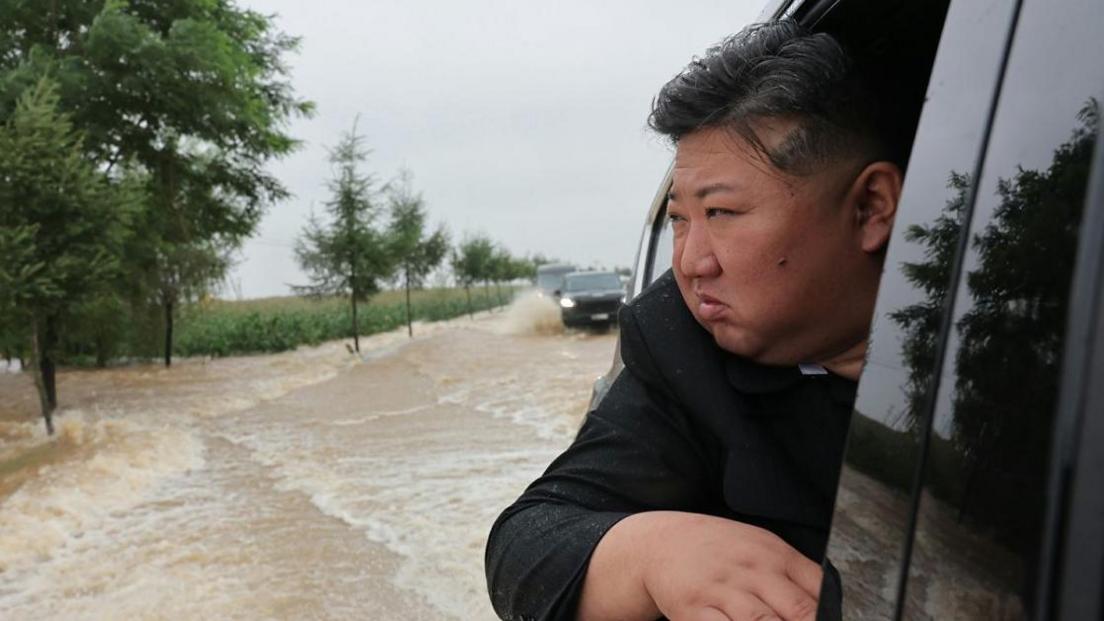 North Korea leader Kim Jong Un travels through a flooded area.