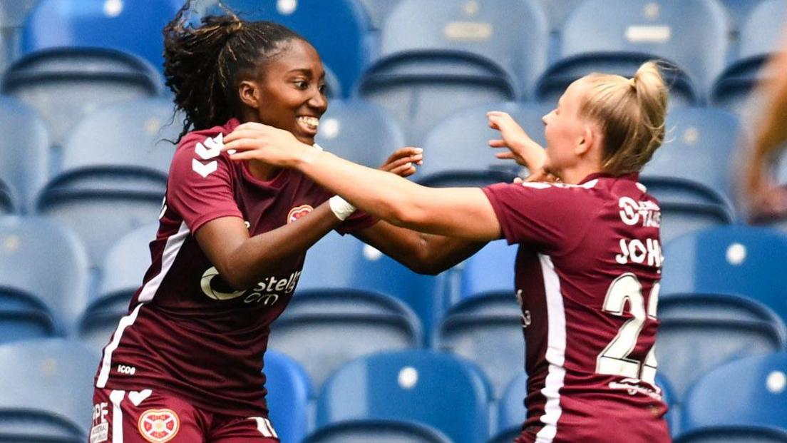 Sade Adamolekun and Carly Johns celebrate