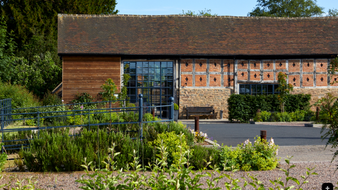 Native is described as a countryside retreat located on the Herefordshire-Worcestershire border. It has a barn conversion building with large windows and gardens around it.
​