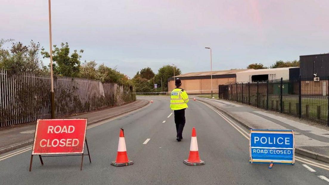 A police officer stands inside the cordon following the incident