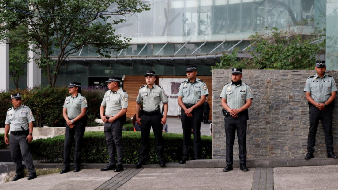 Members of Mexico's National Guard outside the England team's hotel before their arrival for their World Cup last-16 game with Mexico in Mexico City