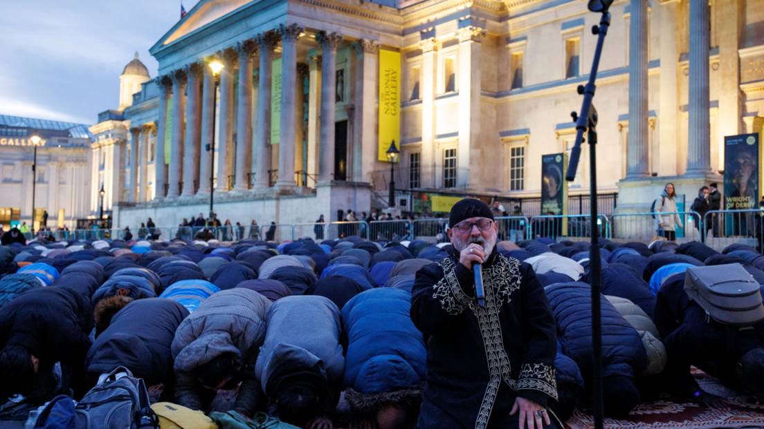 Members of the Muslim community pray ahead of the 'open iftar' Ramadan dinner event at Trafalgar Square in London