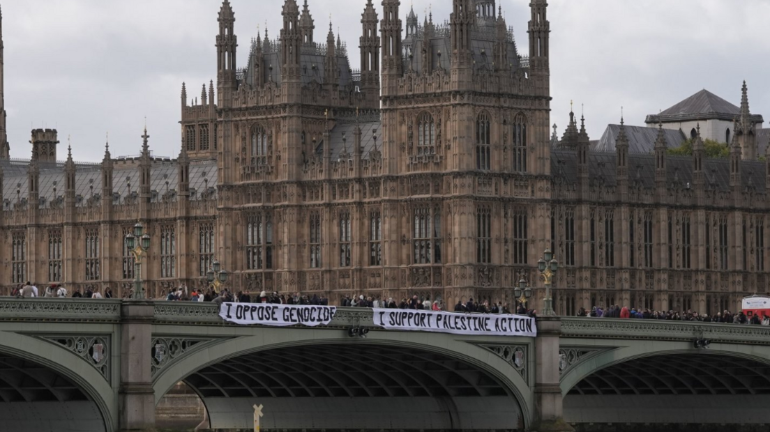 Protesters unfurl a banner on Westminster Bridge as part of a demonstration organised by Defend our Juries