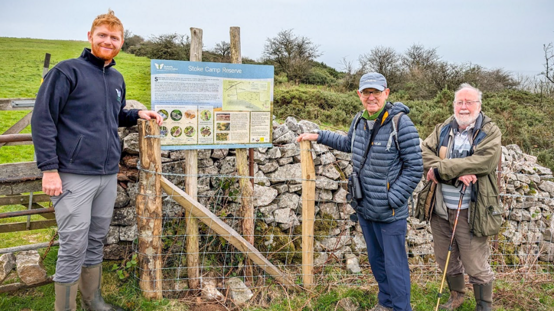 Dr Max Anderson and local volunteers John Ball, Peter Bright stand next to the new fence and a information sign about Stoke Camp Reserve