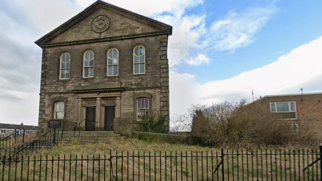 A Victorian Methodist church in Bingley. A stone building with two doors in the centre with a window on each side and four large window above