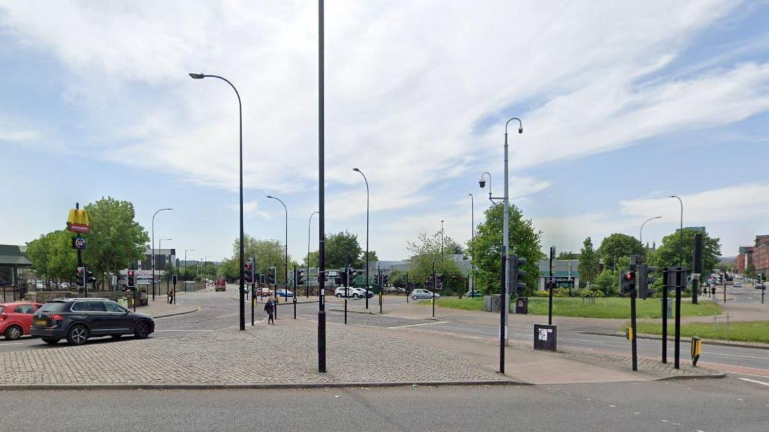 A Google street view image of the junction of Suffolk Road and Granville Road in Sheffield. A McDonald's restaurant is to the left of the image, with a great deal of street furniture such as lamp posts, traffic lights and security cameras. 