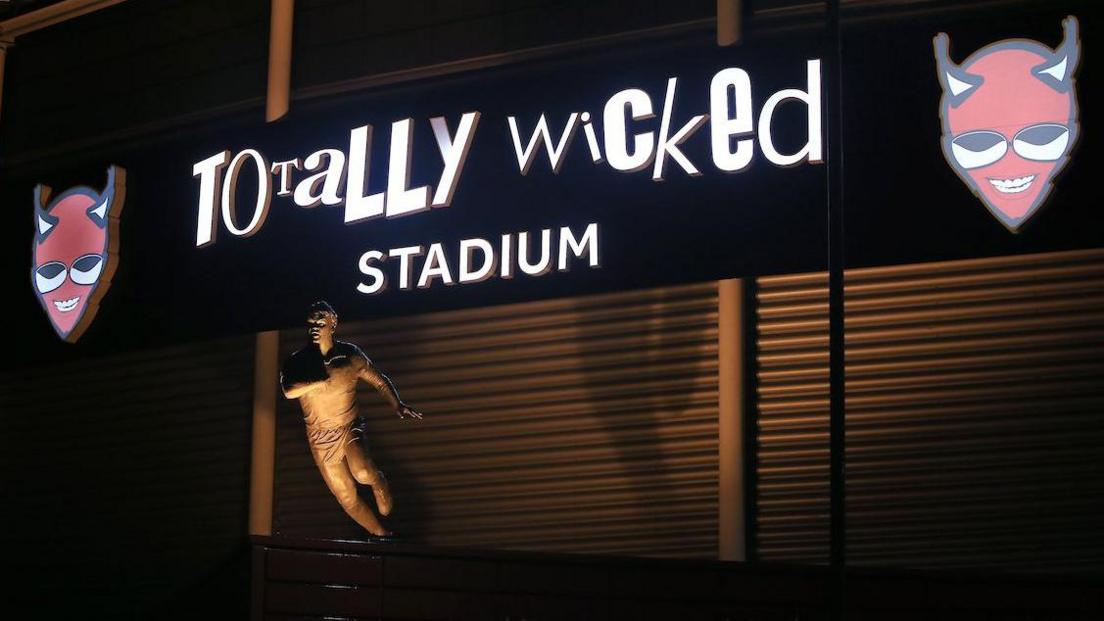 A night time shot of Keiron Cunningham's statue in front of the Totally Wicked Stadium, home of St Helens