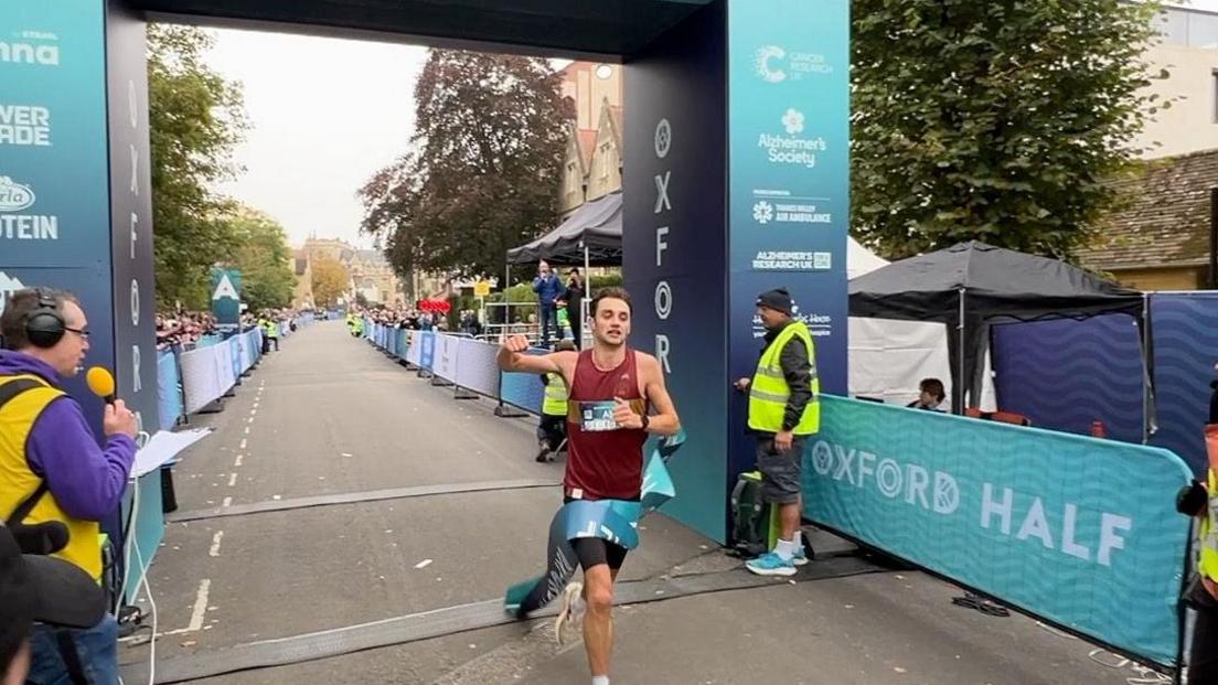 George Grassley crossing the finish line in first.