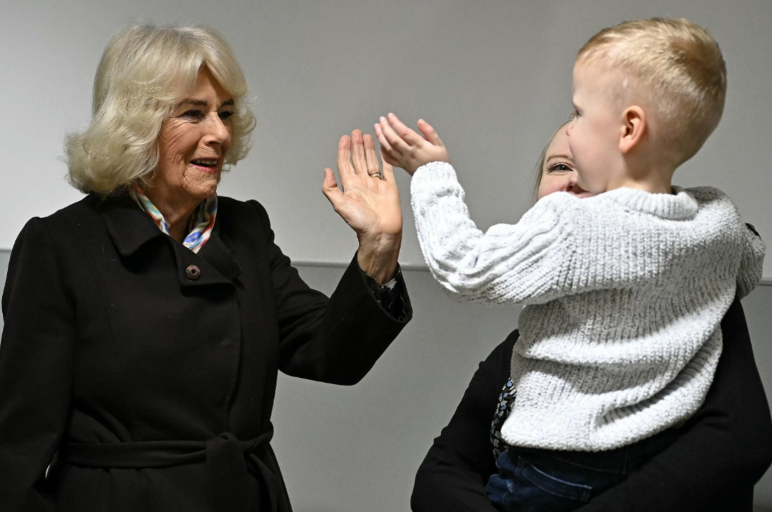 The Queen high-fives a young patients at the Great Western Hospital