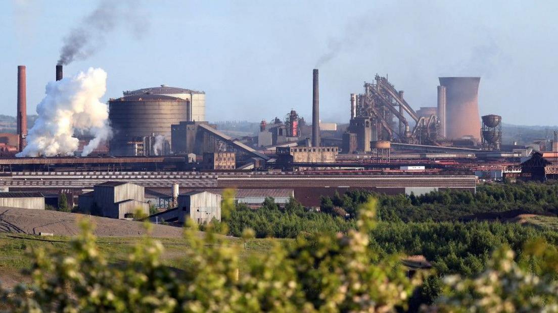 General view of steelworks with buildings and chimneys