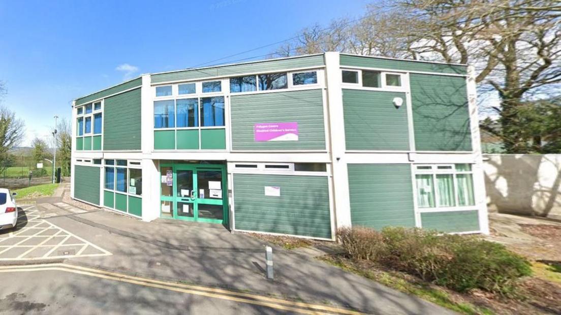 The Polygon Centre in Alfreton. It is green in colour and is shaped like a decagon.