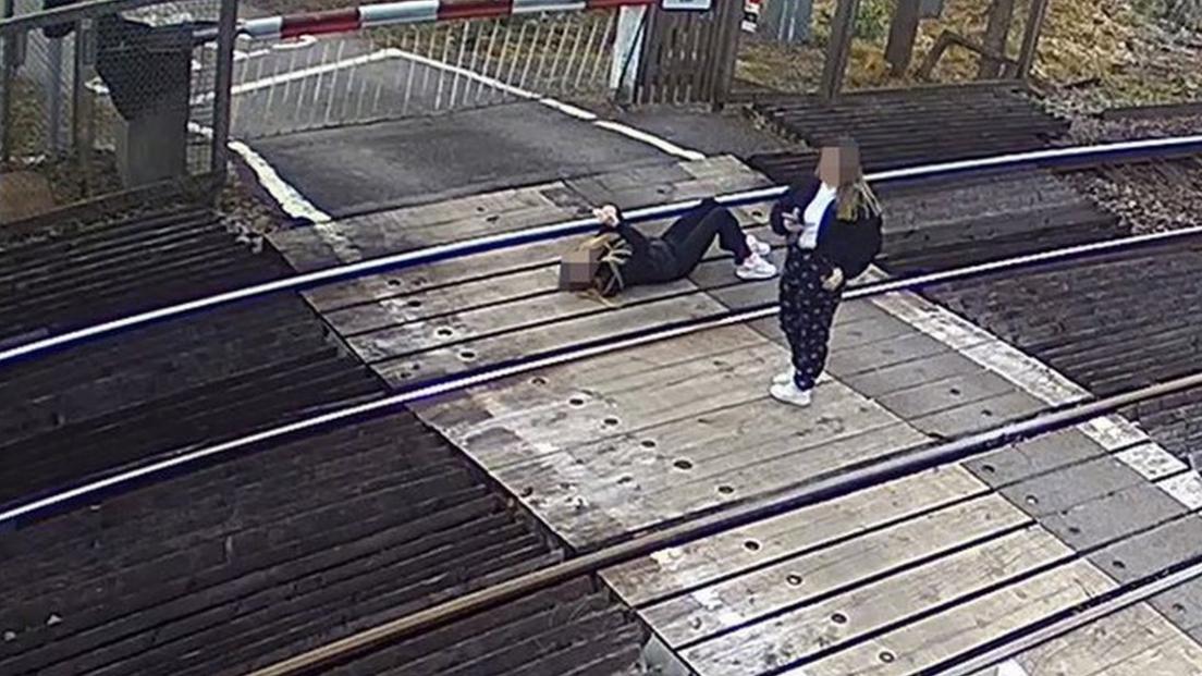 Girl lies on railway line