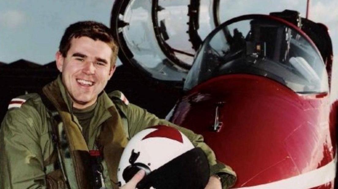 Ian in his trainee RAF pilot uniform standing in front of plane