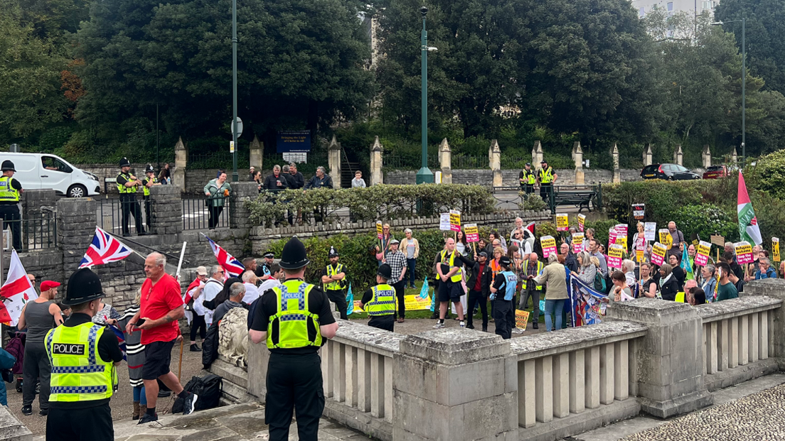 Anti-racism campaigners, to the right of the picture, facing anti-immigration protesters, to the left of the picture, with police surrounding them close to the Cenotaph 