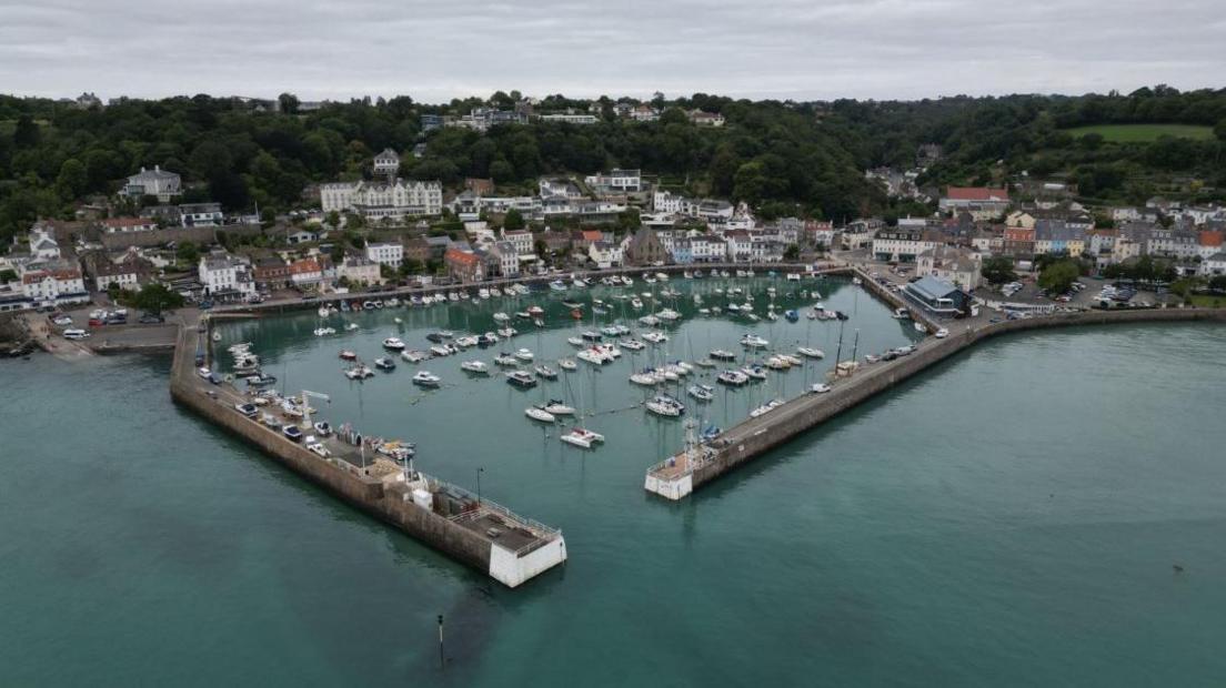 St Aubin, Jersey. The photo is taken at high tide with boats in the harbour. 