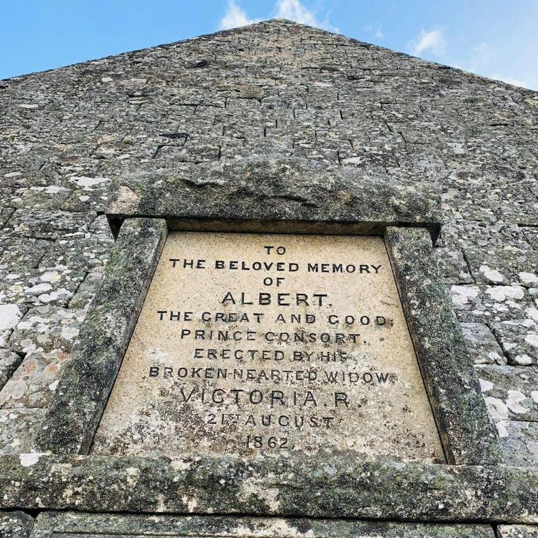 Carved message on cairn which says 'To the beloved memory of Albert, the great and good Prince Consort, erected by his broken-hearted widow Victoria, 21st August 1862'.
